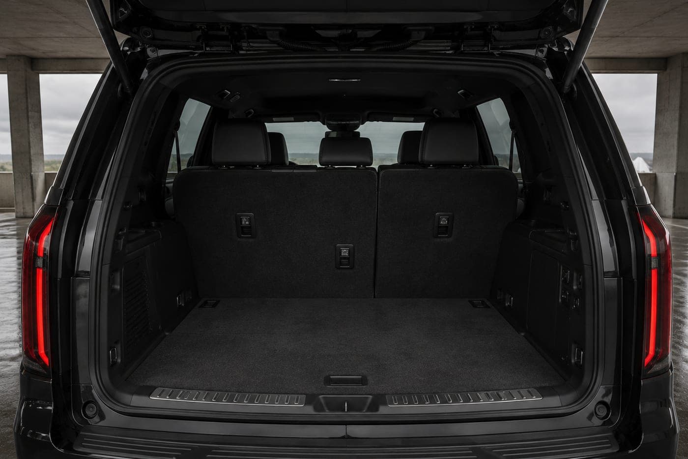 The open, empty cargo area of a large black SUV
