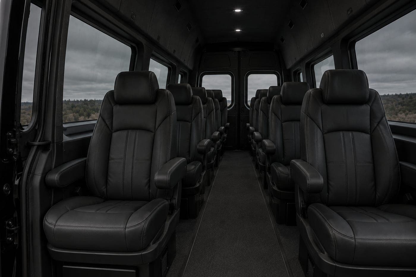 Rows of leather seats down the aisle of a high-roof passenger van