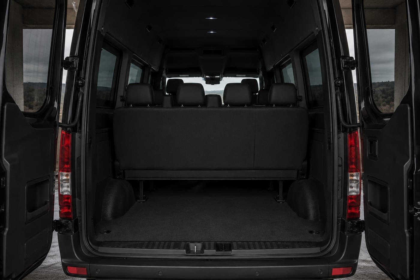 The open, empty luggage area of a black passenger van
